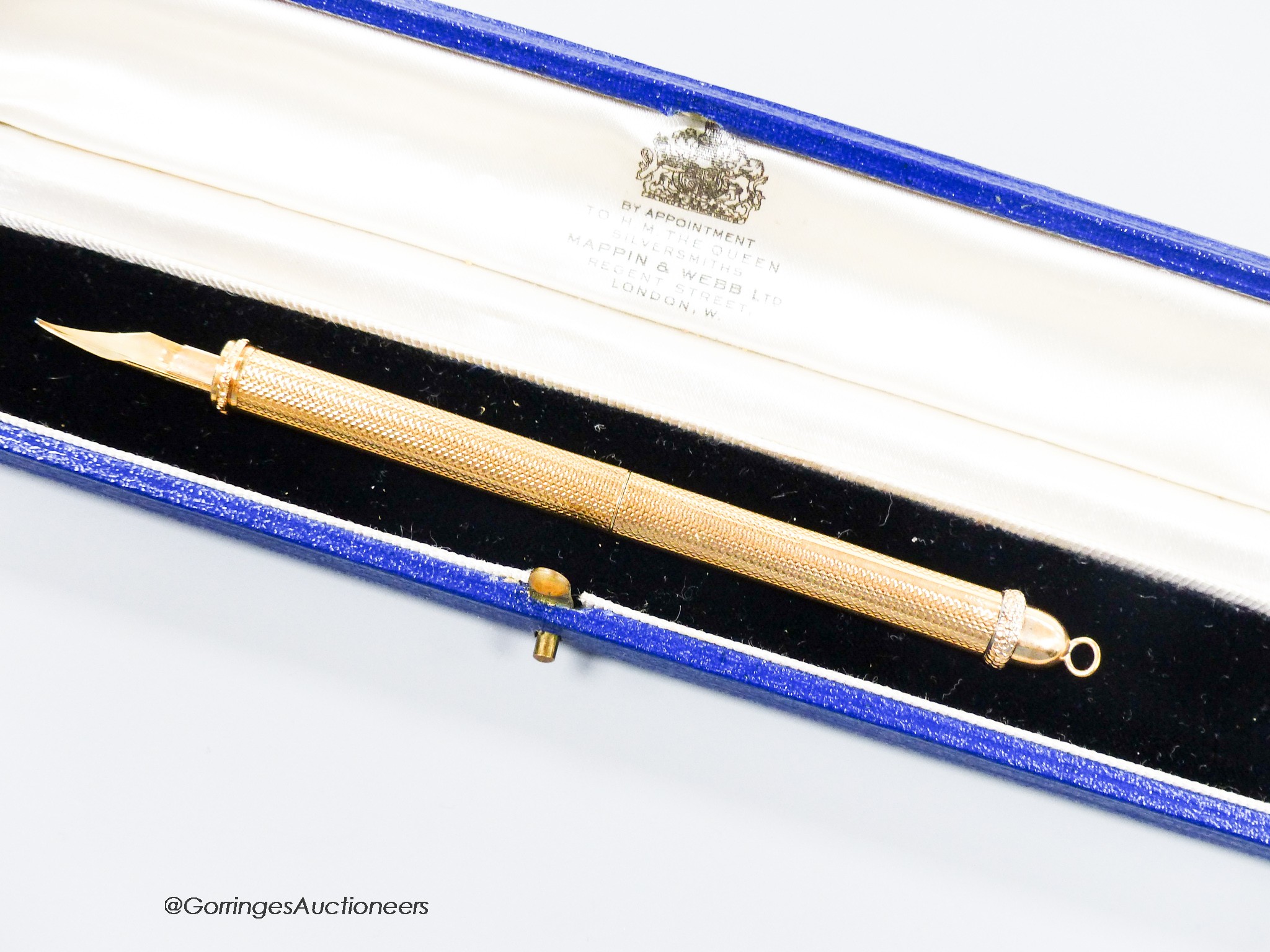 A 1960's engine turned 18k overlaid dip pen, with engraved inscription, 12.9cm, gross weight 24.4 grams.